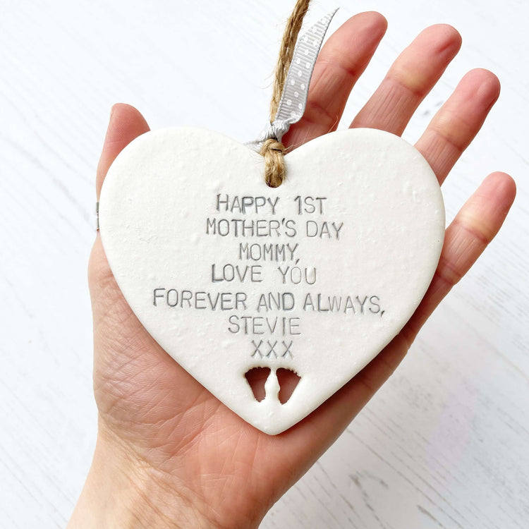 Pearlised white clay heart personalised with HAPPY 1ST MOTHER’S DAY MUMMY, LOVE YOU FOREVER AND ALWAYS, STEVIE XXX with baby feet cut out at the bottom
