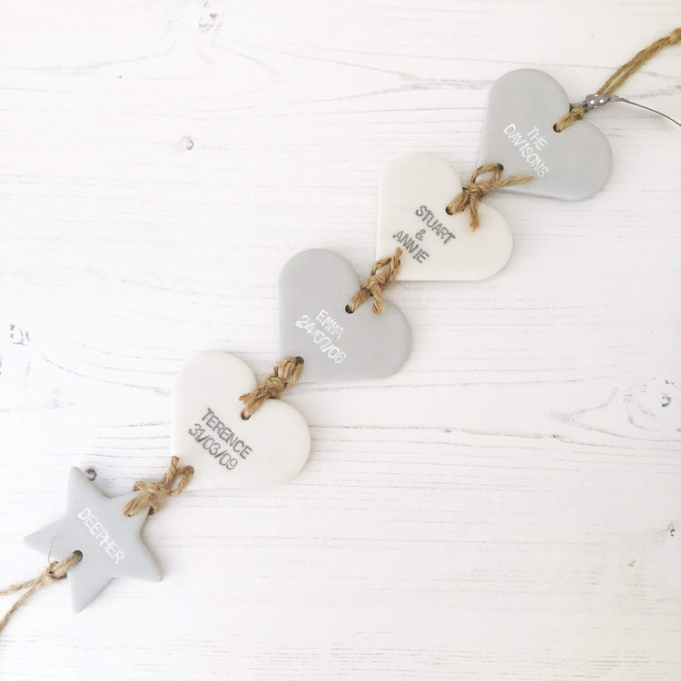 Family tree keepsake, grey small polymer clay heart with a pearlised white small heart hanging below, a small grey heart hanging at the bottom, personalised with family names and dates