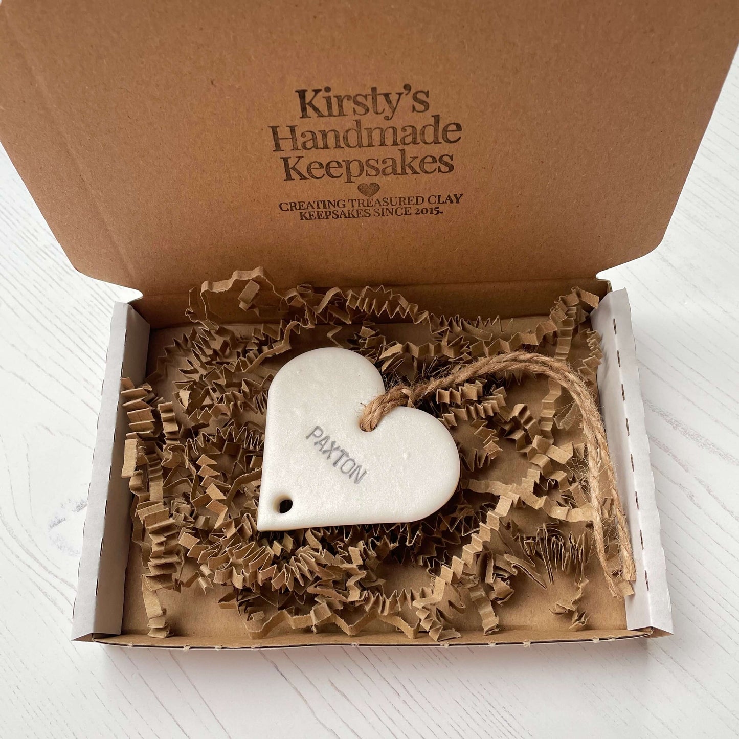 Small pearlised white polymer clay heart family tree add on personalised with Paxton in a white postal box with brown Kraft zigzag shredded paper
