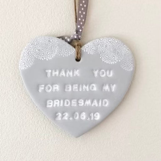 Personalised Bridesmaid thank you gift, grey clay hanging heart with a white lace edge at the top of the heart, the heart is personalised with THANK YOU FOR BEING MY BRIDESMAID 22.06.19