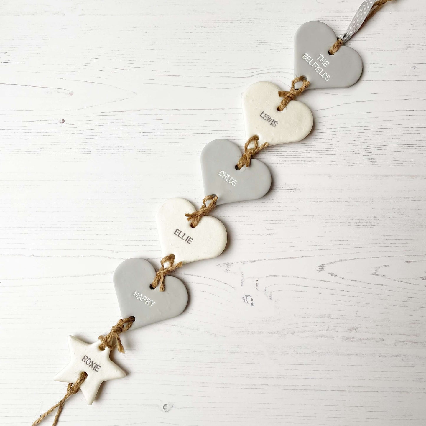 Family tree keepsake, grey small polymer clay heart with a pearlised white small heart hanging below, a small grey heart hanging below, a pearlised white heart hanging below, a grey heart hanging below and a pearlised white star hanging at the bottom, personalised with family names and dates