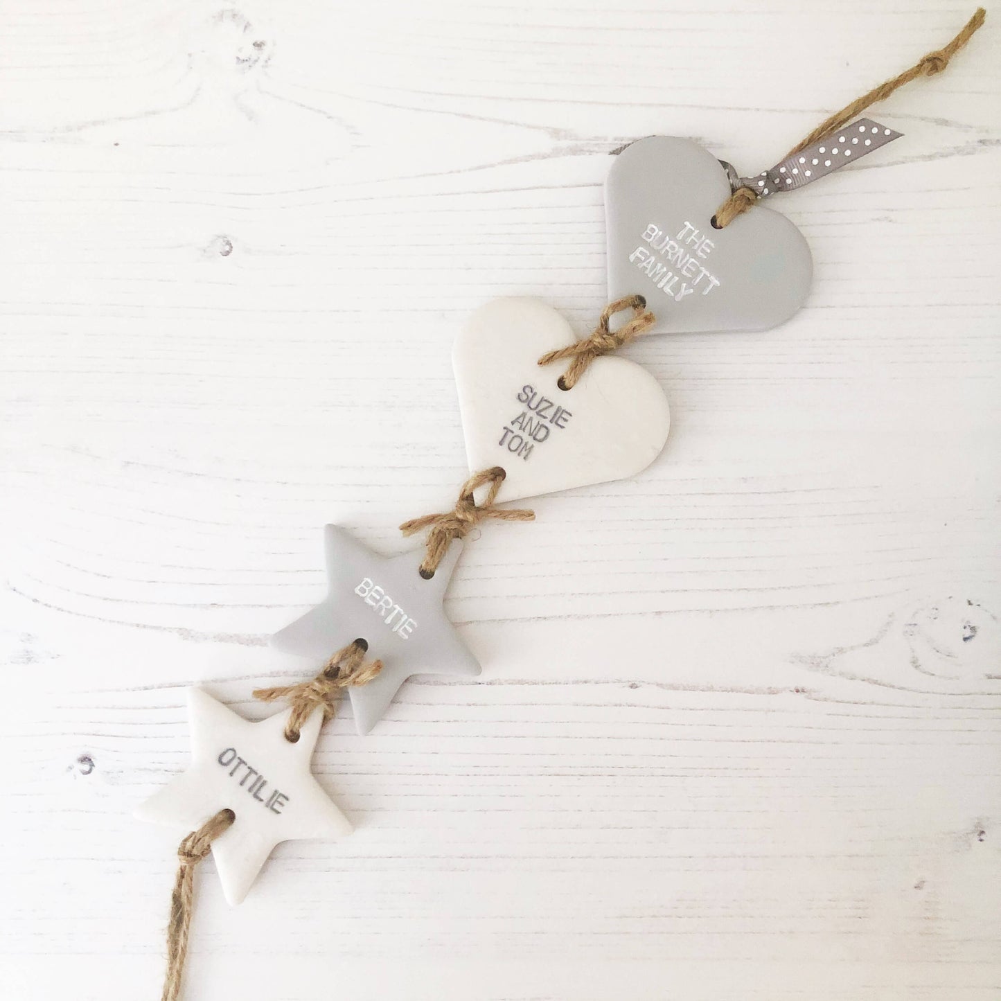 Polymer clay family tree, 2 smalls hearts and 2 small stars personalised with family names, in grey and pearlised white