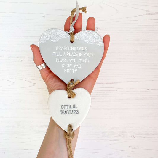 Grandparent keepsake with a large grey polymer clay heart with a quote on and a small pearlised white heart hanging below with a name and date of birth