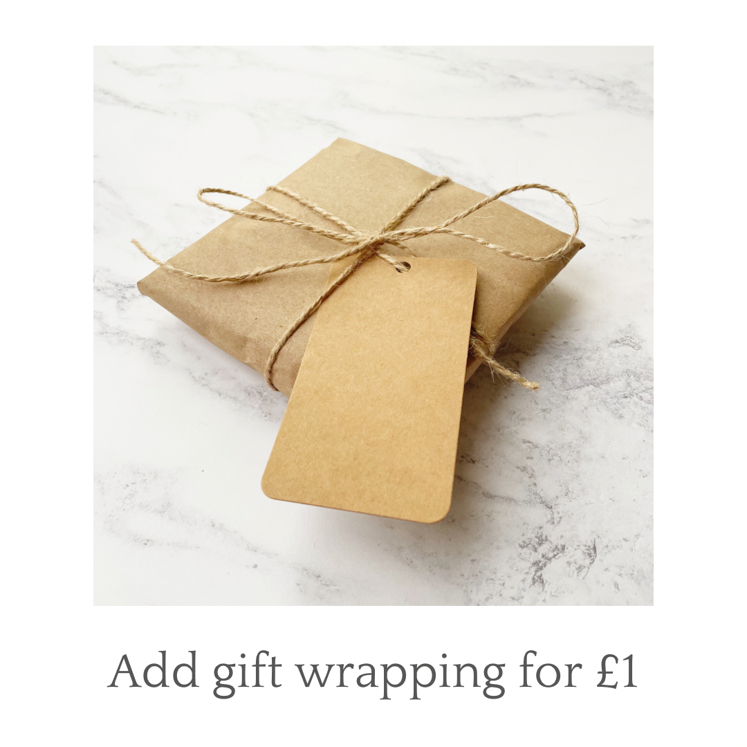 Gift wrapped heart in brown kraft paper and tied with jute twine and finished with a brown Kraft gift tag personalised with your message. Bottom of photo says Add gift wrapping for £1