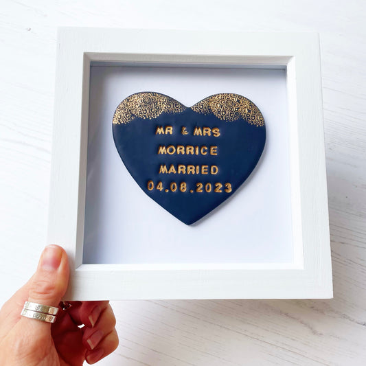 Personalised framed wedding gift, navy clay heart with a gold lace edge at the top of the heart in a white box frame, the heart is personalised with MR & MRS MORRICE MARRIED 04.08.2023