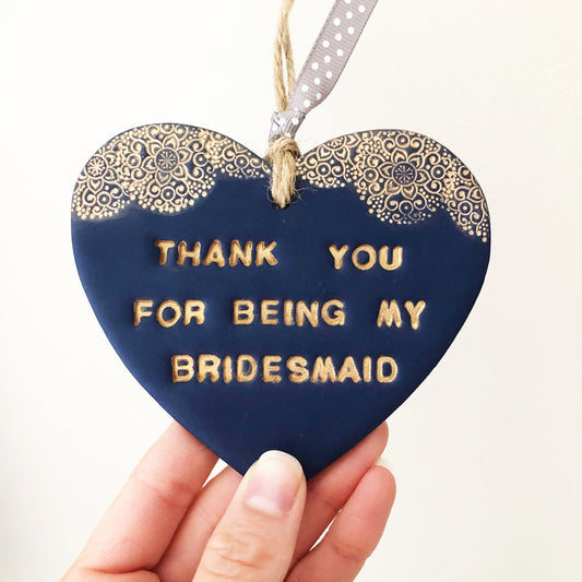 Personalised Bridesmaid thank you gift, navy clay hanging heart with a gold lace edge at the top of the heart, the heart is personalised with THANK YOU FOR BEING MY BRIDESMAID