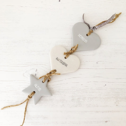Family tree keepsake, grey small polymer clay heart with a pearlised white small heart hanging below, a small grey star hanging at the bottom, personalised with family names and dates