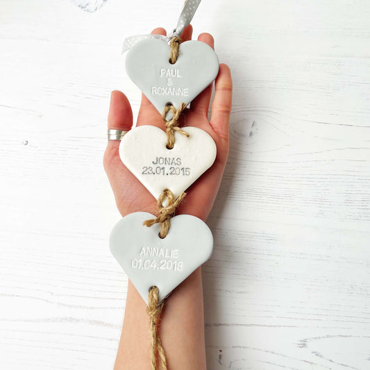 Family tree keepsake, grey small polymer clay heart with a pearlised white small heart hanging below, a small grey heart hanging at the bottom, personalised with family names and dates