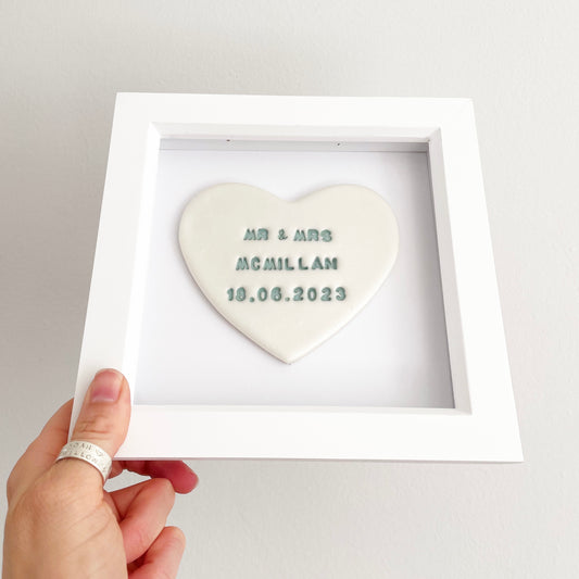 Personalised framed wedding heart gift, pearlised white clay heart in a white box frame, with sage green personalisation with MR & MRS MCMILLAM 18.06.2023