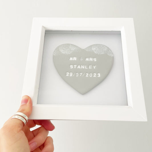 Personalised framed wedding gift, grey clay heart with a white lace edge at the top of the heart in a white box frame, the heart is personalised with MR & MRS STANLEY 29/07/2023