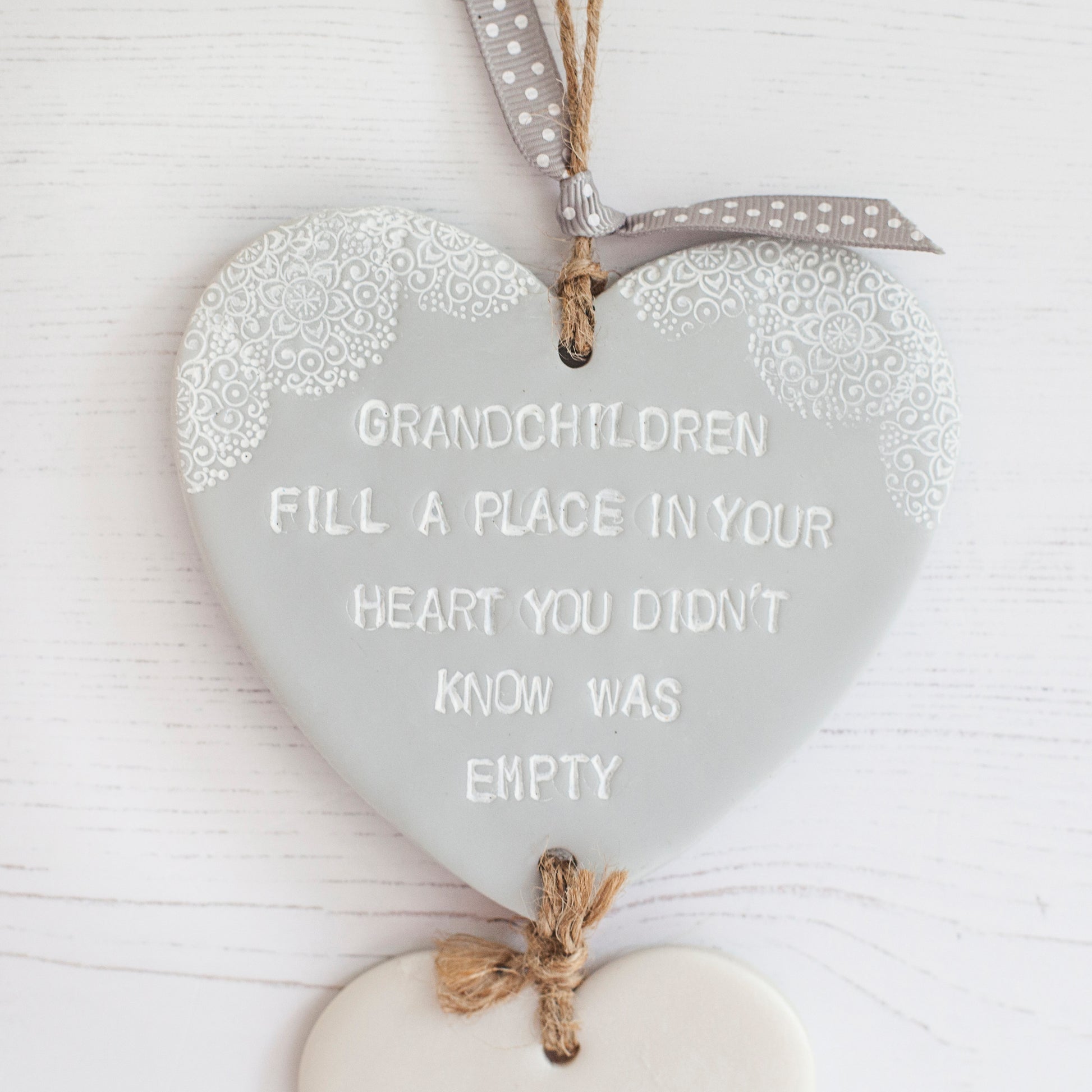 Grandparent keepsake with a large grey polymer clay heart with a quote “Grandchildren fill a place in your heart you didn’t know was empty”