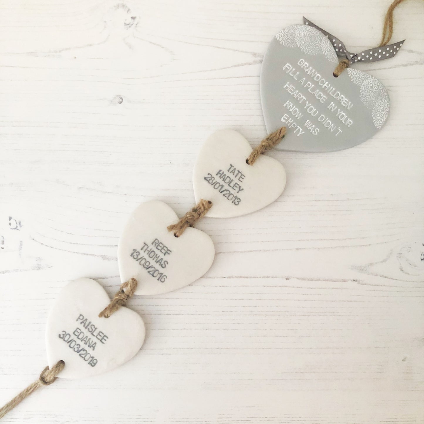 Grandparent keepsake with a large grey polymer clay heart with a quote on and 3 small pearlised white hearts hanging below with a names and dates of birth