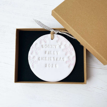 Personalised baby’s first Christmas bauble ornament, glitter white round clay with SONNY’S FIRST CHRISTMAS 2025 (letters not painted), decorated with 3 iridescent glitter snowflakes on either side of the bauble