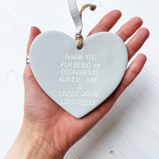 Personalised Godparents gift, grey clay hanging heart personalised in white with THANK YOU FOR BEING MY GODPARENTS AUNTIE AMY & UNCLE JOHN LOVE FELIX