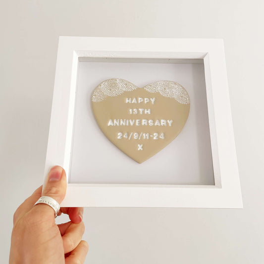 Personalised framed 13th wedding anniversary gift, beige clay heart with a white lace edge at the top of the heart in a white box frame, the heart is personalised with HAPPY 13TH ANNIVERSARY 24/9/11-24 X