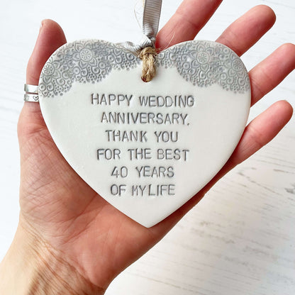 Personalised pearlised white clay hanging hearts with a grey lace edge at the top of the heart, the heart is personalised with HAPPY WEDDING ANNIVERSARY, THANK YOU FOR THE BEST 40 YEARS OF MY LIFE