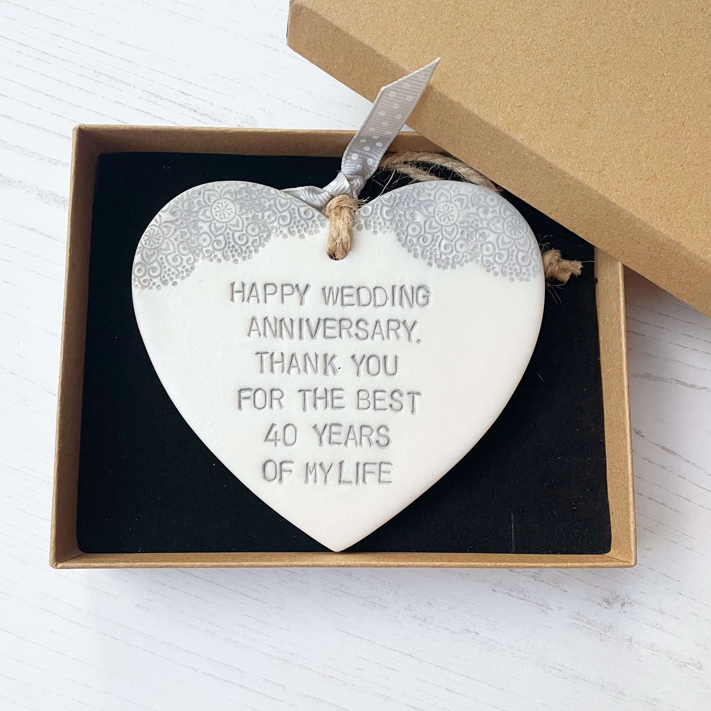 Personalised pearlised white clay hanging hearts with a grey lace edge at the top of the heart, the heart is personalised with HAPPY WEDDING ANNIVERSARY, THANK YOU FOR THE BEST 40 YEARS OF MY LIFE