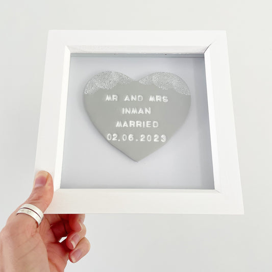 Personalised framed wedding gift, grey clay heart with a white lace edge at the top of the heart in a white box frame, the heart is personalised with MR AND MRS INMAN MARRIED 02.06.2023