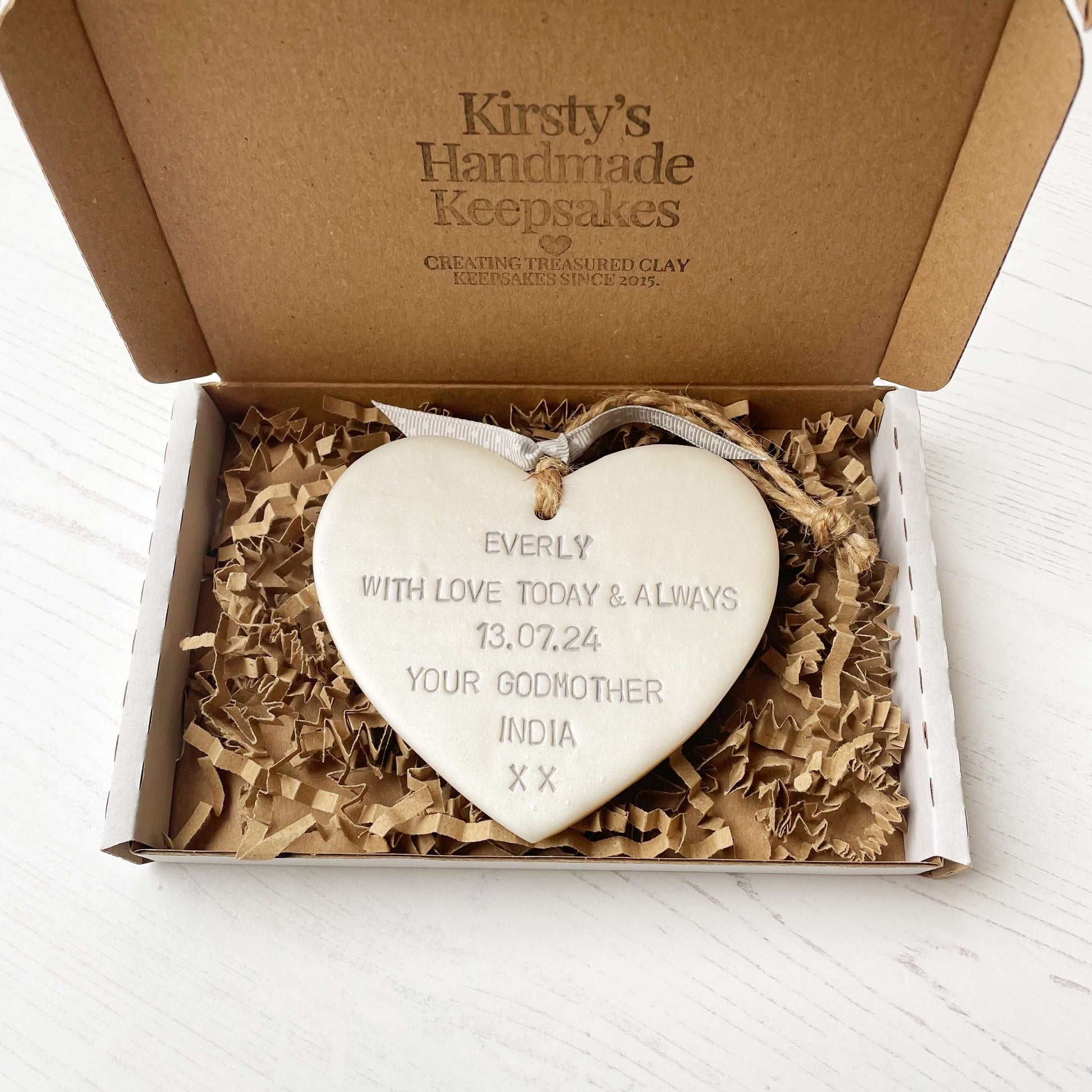 Personalised Christening baptism gift, pearlised white clay hanging heart, the heart is personalised in grey with EVERLY WITH LOVE TODAY & ALWAYS 13.07.24 YOUR GODMOTHER INDIA XX