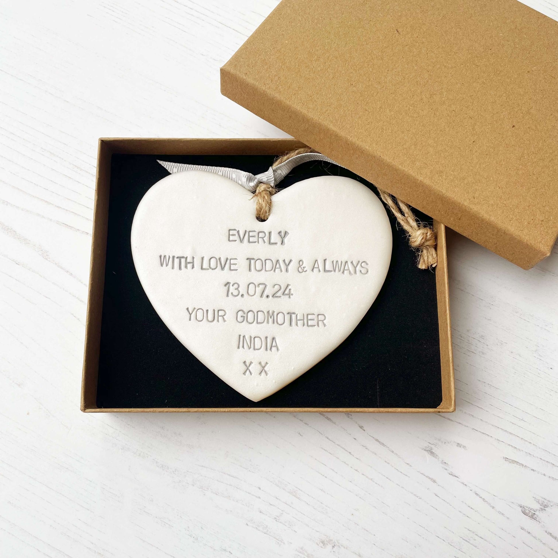 Personalised Christening baptism gift, pearlised white clay hanging heart, the heart is personalised in grey with EVERLY WITH LOVE TODAY & ALWAYS 13.07.24 YOUR GODMOTHER INDIA XX
