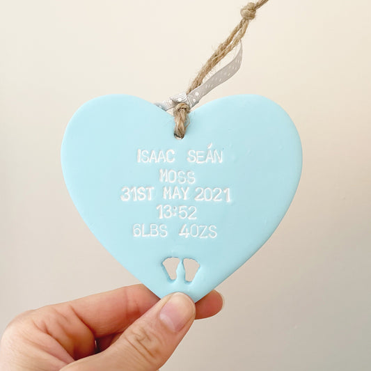 Personalised baby keepsake gift, pastel blue clay hanging heart with baby feet cut out at the bottom of the heart, the heart is personalised with the baby’s name, date of birth, weight and time