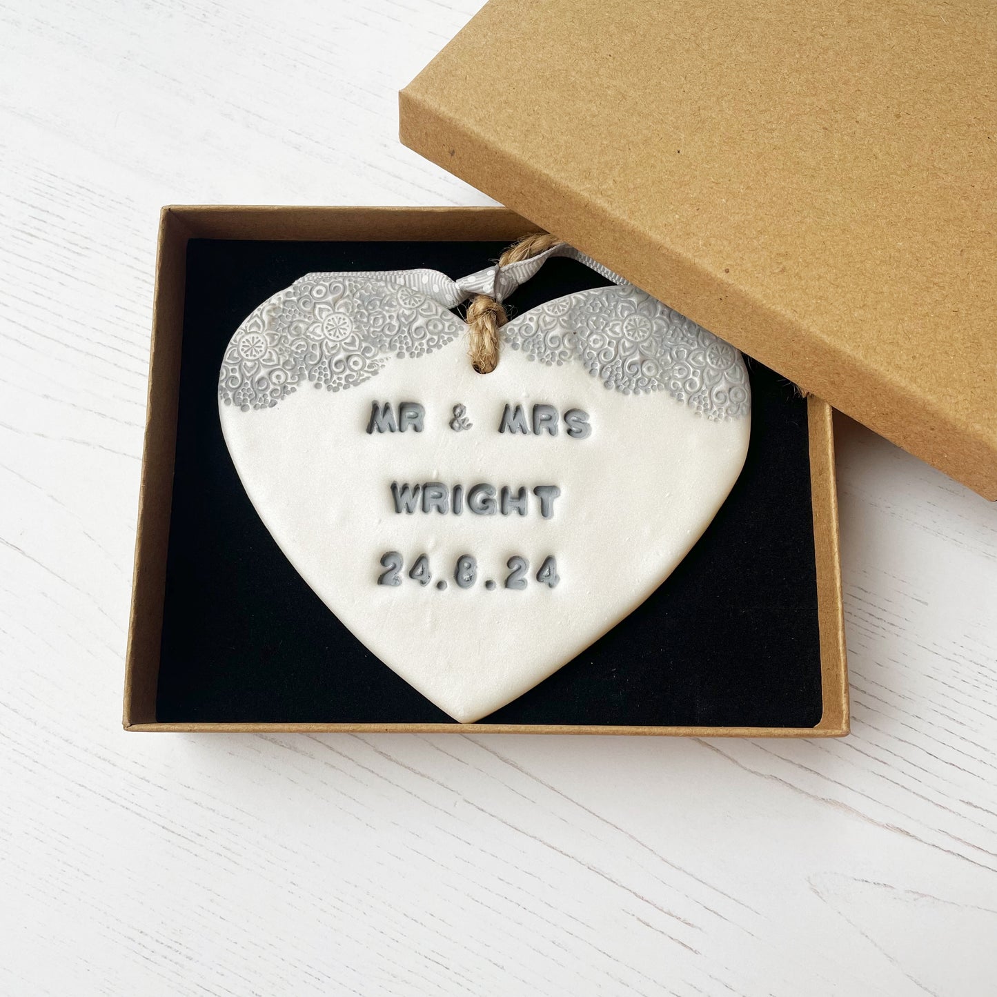 Personalised wedding gift, pearlised white clay hanging heart with a grey lace edge at the top of the heart, the heart is personalised with MR & MRS WRIGHT 24.8.24