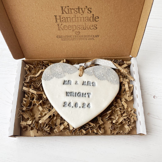 Personalised wedding gift, pearlised white clay hanging heart with a grey lace edge at the top of the heart, the heart is personalised with MR & MRS WRIGHT 24.8.24