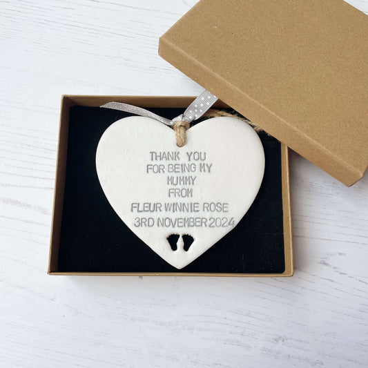 Personalised Mother’s Day gift, pearlised white clay hanging heart with baby feet cut out at the bottom of the heart, the heart is personalised with THANK YOU FOR BEING MY MUMMY FROM FLEUR WINNIE ROSE 3RD NOVEMBER 2024